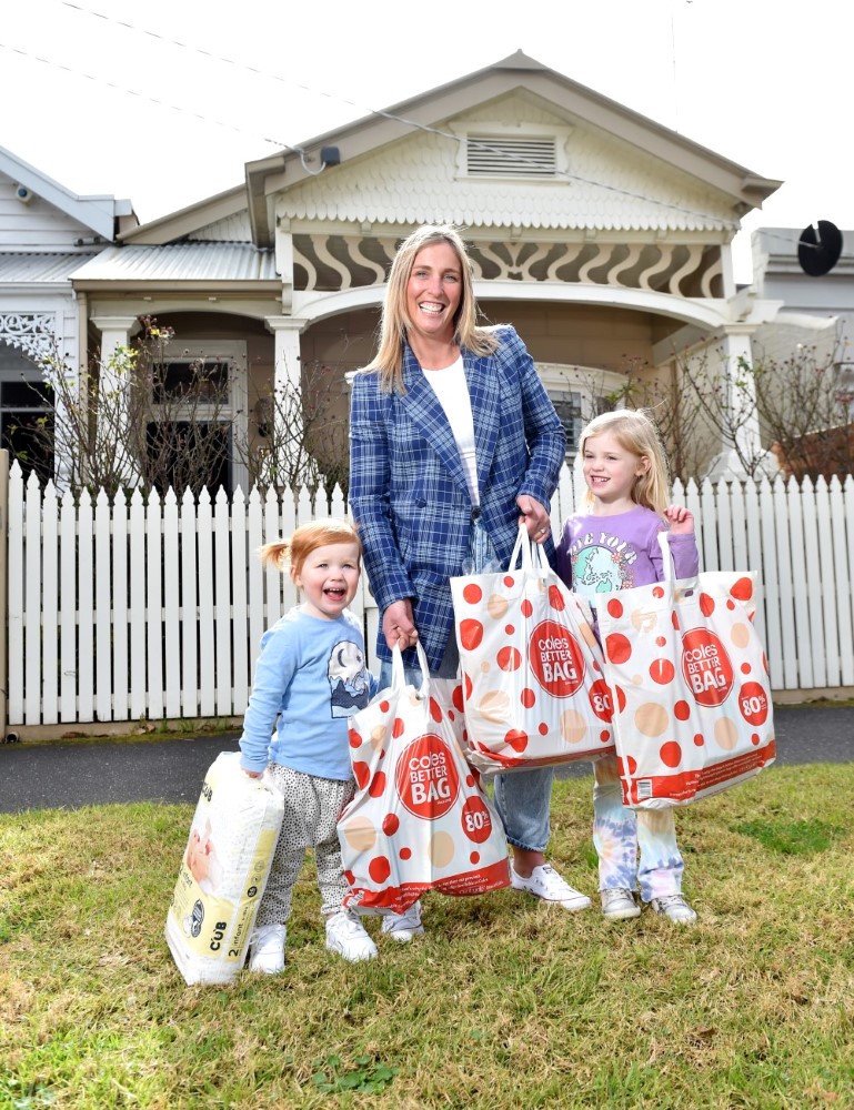 Victorian mum Jess Lonergan and daughters Hope and Missy with great value groceries from Coles, as Coles locks the price of more than 1100 products until 2023. 